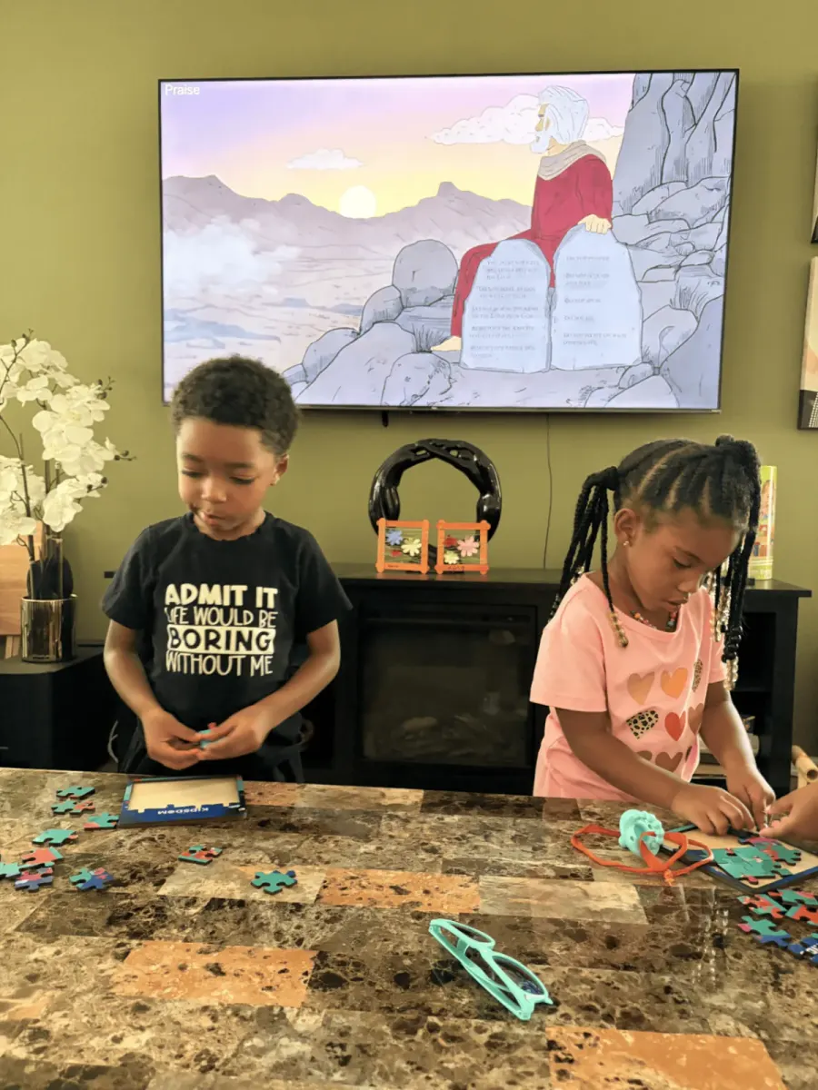 Children building Bible story puzzles during an interactive online preschool lesson