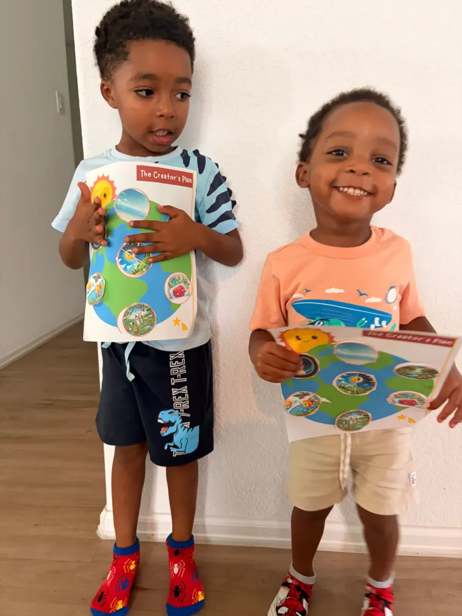 Online preschool students showing their Bible craft during a live hands-on class