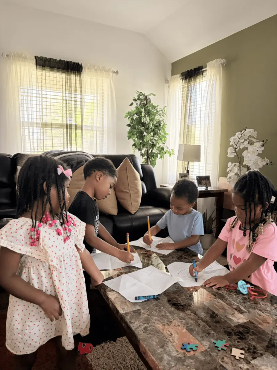 Preschool students practicing letter tracing in a live online kindergarten readiness class