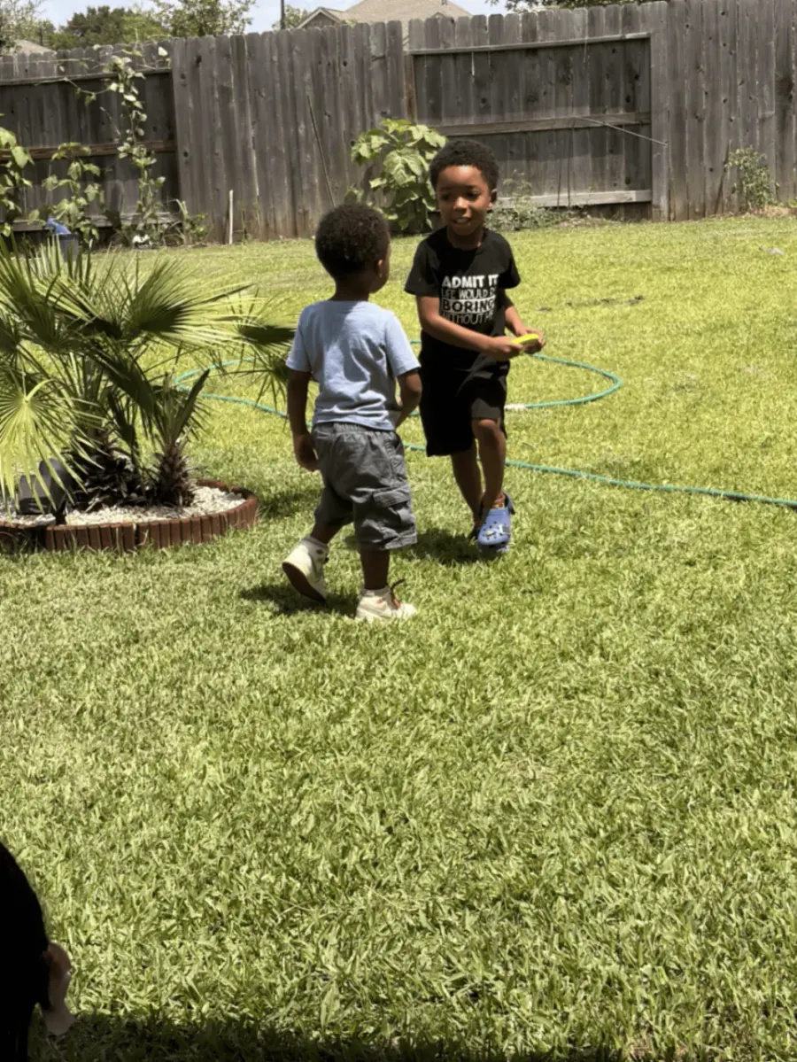 Preschool boys running and playing outside to develop gross motor skills