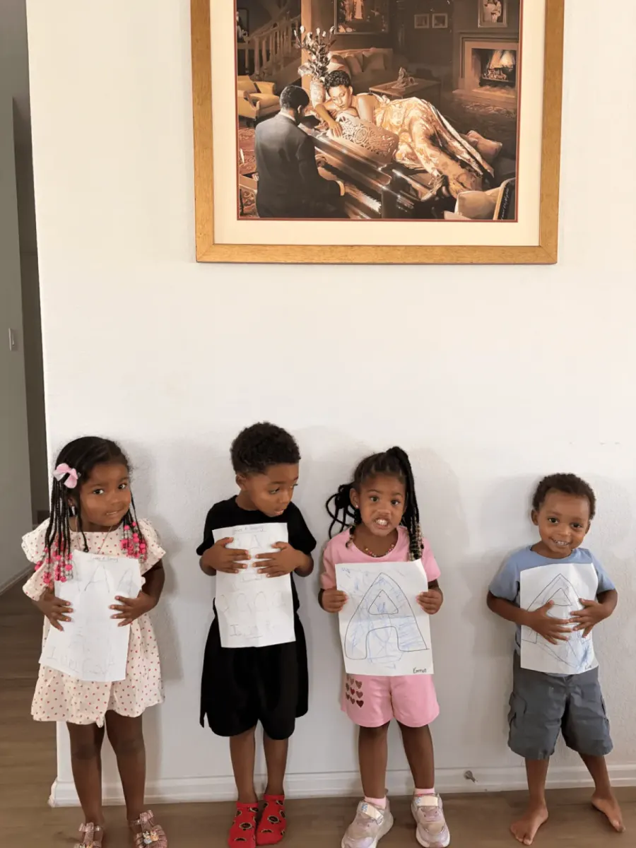 Preschool students practicing the letter A with worksheets and crayons