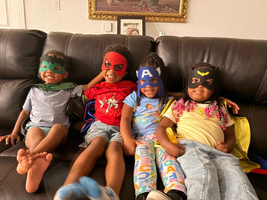 Preschool children playing together in superhero masks to build social skills